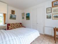 a white bedroom with a bed and a window at Apartment Le Chalet by Interhome in Cabourg