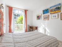 a bedroom with a bed and a window and a desk at Apartment Le Chalet by Interhome in Cabourg