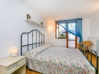 A bed or beds in a room at Apartment Bucaneve by Interhome
