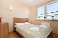 Posteľ alebo postele v izbe v ubytovaní Rezydencja Spacerowa Apartamenty by Noclegi Renters