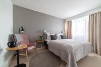 a bedroom with a bed and a table and a chair at Hotel Sparre in Porvoo