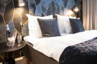 a bedroom with a bed with white sheets and pillows at Hotel Sparre in Porvoo