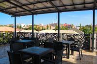 a group of tables and chairs on a patio at Fahrenheit Apartments in Abuja