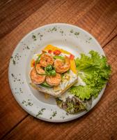a plate of food with shrimp and lettuce on a table at Fleur Lodge in Carhuaz