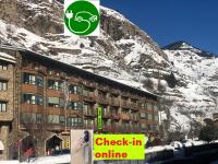 a sign in front of a building with a mountain at Andorra4days Canillo in Canillo