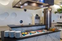 a buffet line with pies and plates on a counter at Arinara Beach Resort Phuket - SHA Extra Plus in Bang Tao Beach