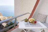 a white table with a bowl of fruit on a balcony at Home2Book Charming Duplex Tabaiba in Tabaiba