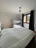 a bedroom with a large white bed and a window at Appartement Le Lauzet in La Roche-de-Rame