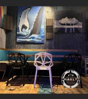 ホニングスヴォーグにあるArctic Boutique Hotel Northcapeのカウンターの前に椅子2脚とピンクのスツール