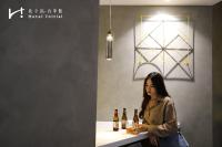 a woman standing at a counter with bottles of wine at Hotel Initial-Taichung in Taichung