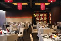 a restaurant with white tables and chairs and red lights at Taj Mahal, New Delhi in New Delhi