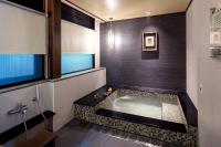 a bathroom with a bath tub in a room at Great Roots Forestry Spa Resort in Sanxia