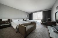 a hotel room with a bed and a couch at Taipung Suites in Anping