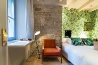 a bedroom with a bed and a desk and a chair at The Melegran in Rovinj
