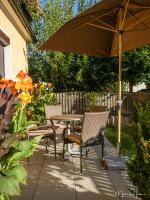 a patio with a table and chairs and an umbrella at Pension Ehrenfried - Hotel garni in Kindberg