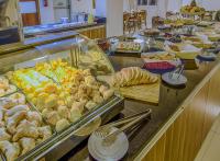 a buffet line with many different types of food at Klein Ville São Leopoldo in São Leopoldo
