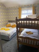 a bedroom with two bunk beds and a window at JEANNE in Blackpool