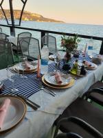 a table with plates of food and a view of the ocean at Regina Maria Spa Design Hotel in Balchik