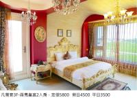 a bedroom with a king sized bed with red walls at Jane Castle in Wujie