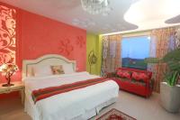 a bedroom with a bed and a red wall at Jane Castle in Wujie