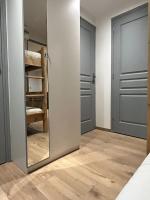 a bedroom with two doors and a mirror at Appart au centre de la station, entièrement rénové, , parking privé et wifi gratuit in Les Deux Alpes