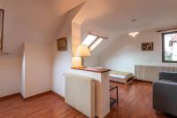 a living room with a bed and a lamp on a table at Pleasant apartment three minutes from the center of Annecy in Annecy