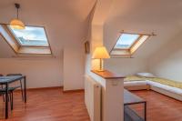 a room with skylights and a bed and a table at Pleasant apartment three minutes from the center of Annecy in Annecy