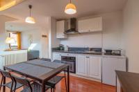 a kitchen with a table and chairs in a room at Pleasant apartment three minutes from the center of Annecy in Annecy