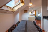 a dining room with a table and a skylight at Pleasant apartment three minutes from the center of Annecy in Annecy