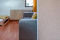 a room with a blue chair and a bed at Pleasant apartment three minutes from the center of Annecy in Annecy