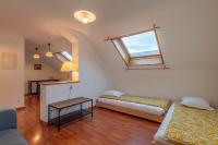 a living room with a bed and a table at Pleasant apartment three minutes from the center of Annecy in Annecy