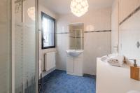a white bathroom with a sink and a mirror at Pleasant apartment three minutes from the center of Annecy in Annecy