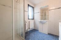 a bathroom with a sink and a glass shower at Pleasant apartment three minutes from the center of Annecy in Annecy