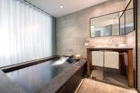 a swimming pool in a bathroom with a sink at Wulai Pause Landis Resort in Wulai