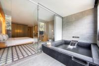 a bathroom with a bath tub with a shower at Wulai Pause Landis Resort in Wulai