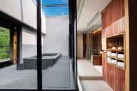 a bathroom with a tub and a window at Wulai Pause Landis Resort in Wulai