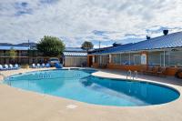 a large swimming pool in front of a building at The Classic Desert Aire Hotel in Alamogordo