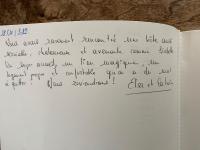 a handwritten note on a white book with handwriting at La coccinelle in Noyarey