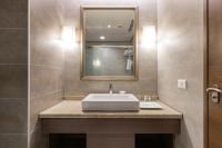 a bathroom with a sink and a mirror at Great Roots Forestry Spa Resort in Sanxia
