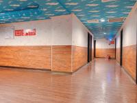 an empty gymnasium with wood floors and a blue ceiling at Centre Hotel in Kaohsiung