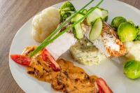 a plate of food with meat and vegetables on a table at ALKA Sun Resort in Ustronie Morskie