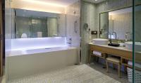 a bathroom with a large tub and two sinks at Chateau de Chine Xinzhuang in Xinzhuang
