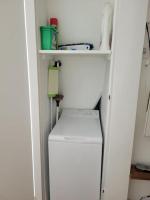a white refrigerator in a room with a shelf at Modern Design One Bedroom Apartment in Paris