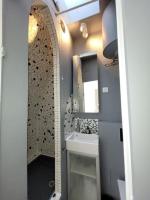 a bathroom with a sink and a mirror at Modern Design One Bedroom Apartment in Paris