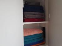 a closet with colorful towels on a shelf at Modern Design One Bedroom Apartment in Paris
