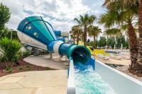 a water slide in a resort with a pool at Bungalow de 3 chambres avec piscine partagee et terrasse a Vias a 1 km de la plage in Vias
