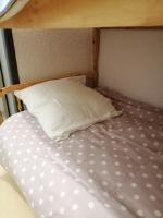 a bunk bed with a pillow and a pillowcase on it at petit nid montagnard in Rousset