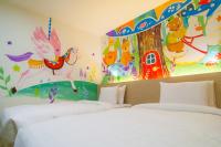 a bedroom with two beds and a mural at Legend Hotel Kaohsiung Liuhe in Kaohsiung