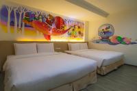 a hotel room with two beds and a painting on the wall at Legend Hotel Kaohsiung Liuhe in Kaohsiung