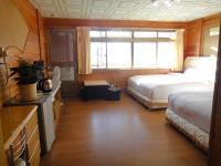 a hotel room with two beds and a window at Bunbury Fruit Ranch B&amp;B in Ren&#39;ai